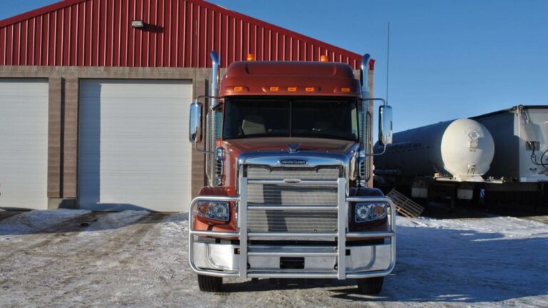 Red Freightliner Truck with RIGGUARD Grille Guard in Front of Warehouse in the Winter