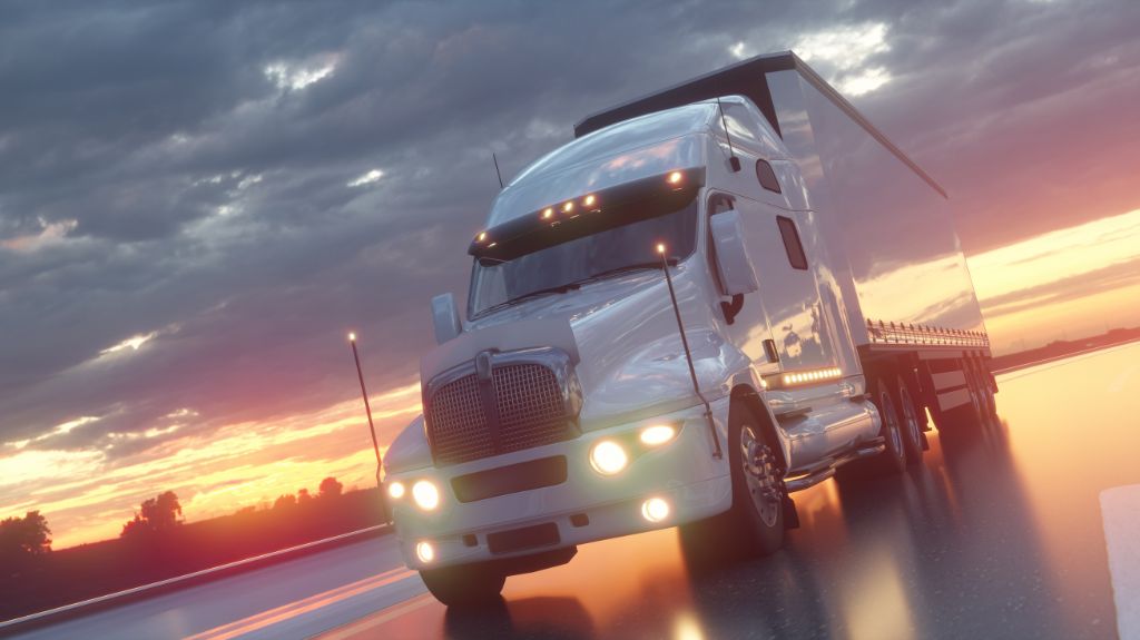 White Semi Truck on a Wet Road at Sunset