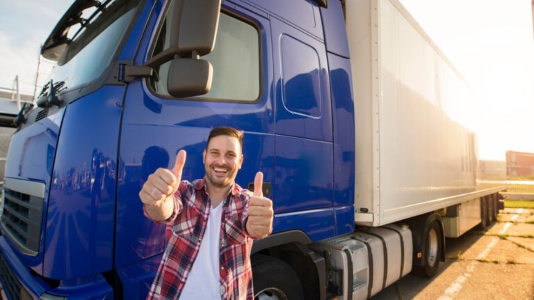 Man Giving Two Thumbs Up in Front of Blue Truck