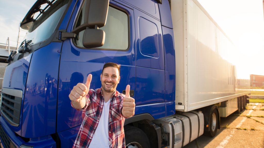 Man Giving Two Thumbs Up in Front of Blue Truck