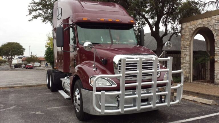 Maroon Semi Truck with RIGGUARD Grille Guard in a Parking Lot
