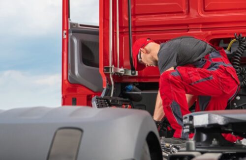 Mechanic Working on a Red Semi Truck