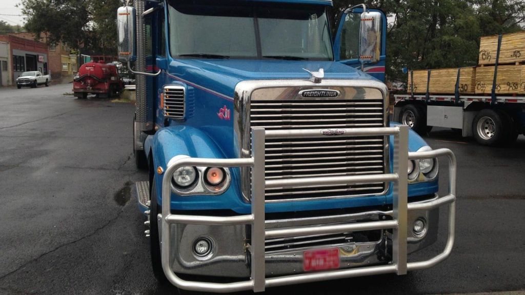 Blue Freightliner with RIGGUARD Grille Guard in Parking Lot