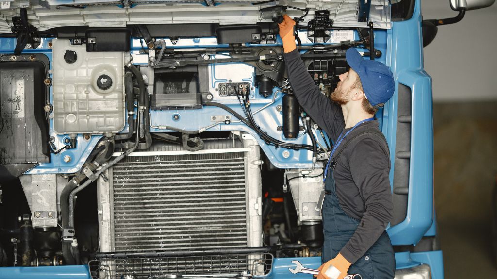 Mechanic Working on a Semi Truck with the Hood Up
