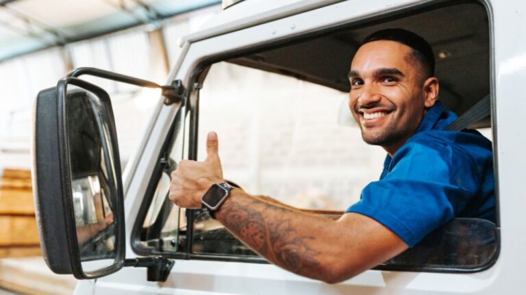 Truck Driver in Cab of a Truck Giving Thumbs Up