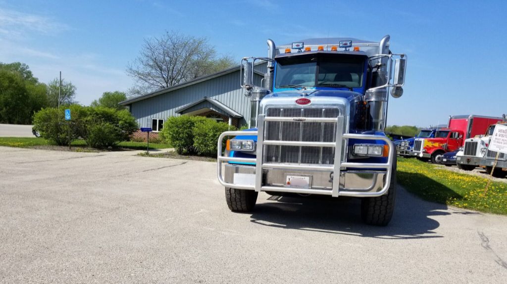 Blue Peterbilt Truck with RIGGUARD Grille Guard in Parking Lot