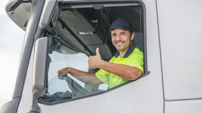Truck Driver in Driver's Seat Giving Thumbs Up