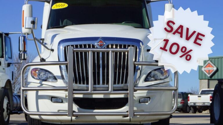 White Semi Truck with RIGGUARD Grille Guard in a Parking Lot with White Save 10% Graphic